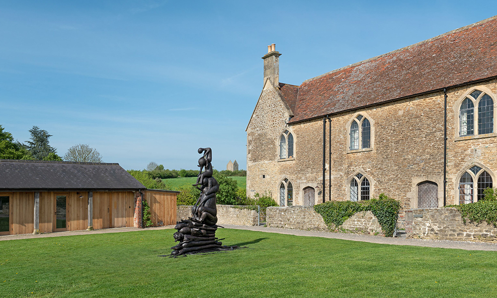 Camille Henrot’s sculpture ‘Family of Men’ (2022) infront of Durslade Farmhouse, 2022 © Camille Henrot. Photo: Ken Adlard