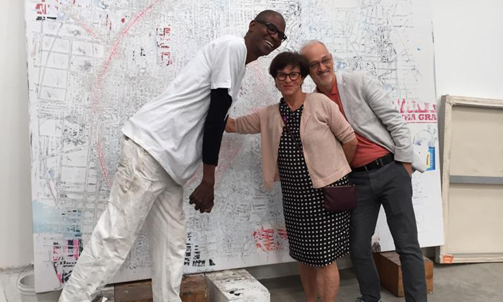 Ursula and André Remund with Mark Bradford in his studio, Los Angeles, 2016