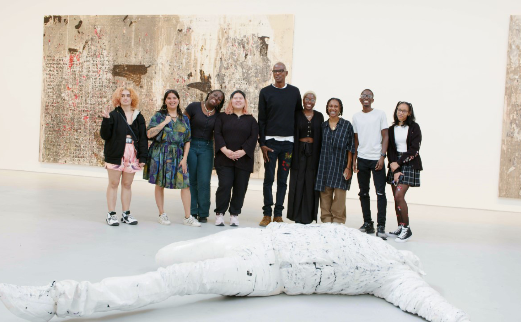 Mark Bradford with young people from Culture for One inside his exhibition at Hauser & Wirth New York, 22nd Street